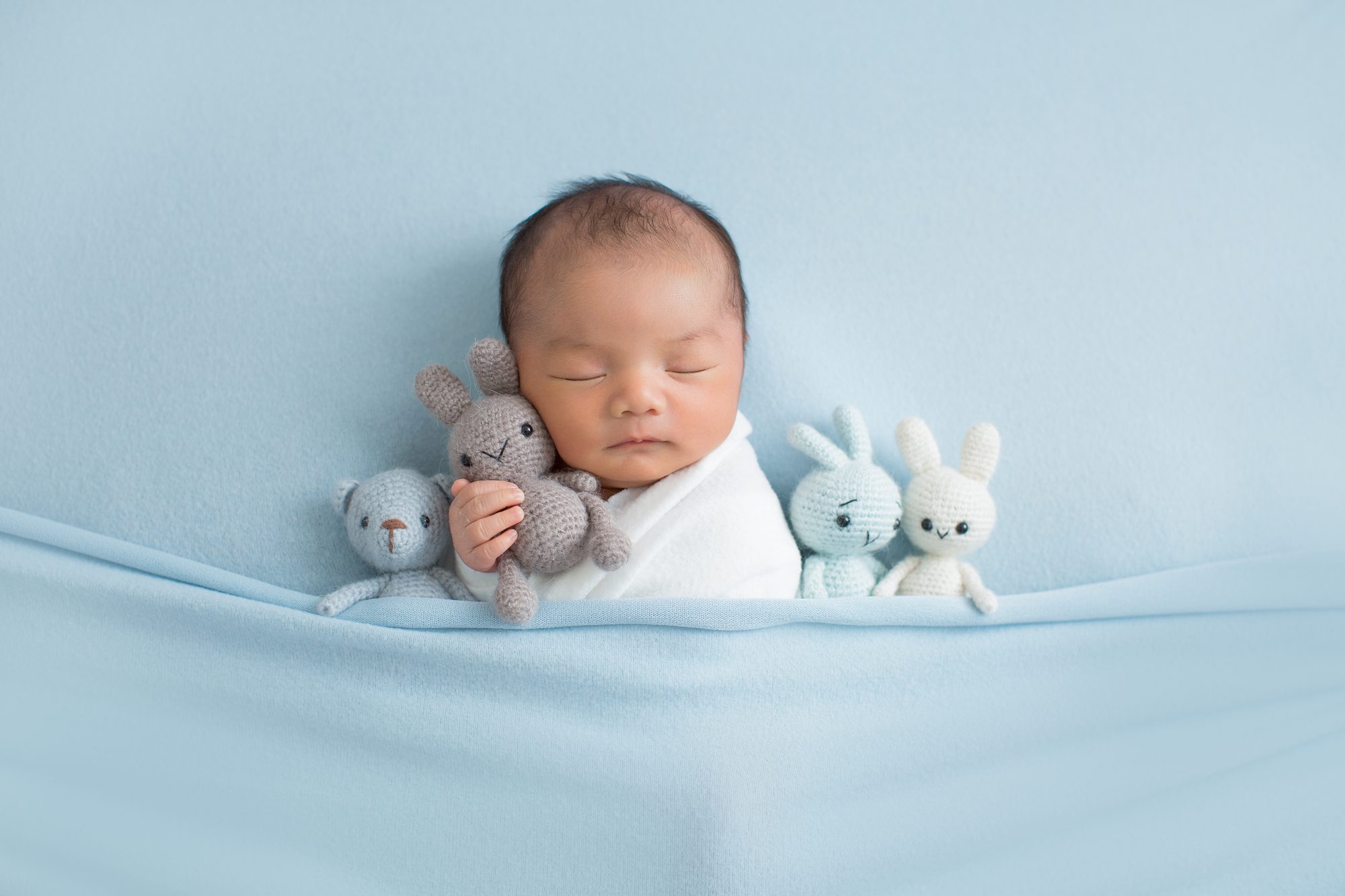 cute baby boy sleeping peacefully during his newborn session